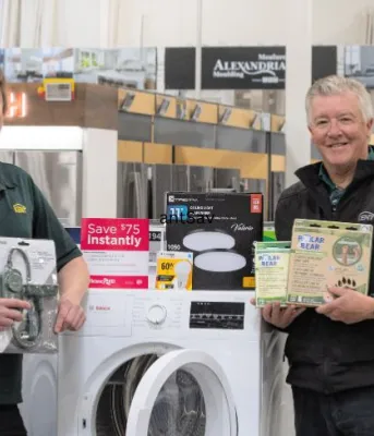 Save on energy efficient products and your energy bill image of two employees in a store standing in front of a washer and dryer