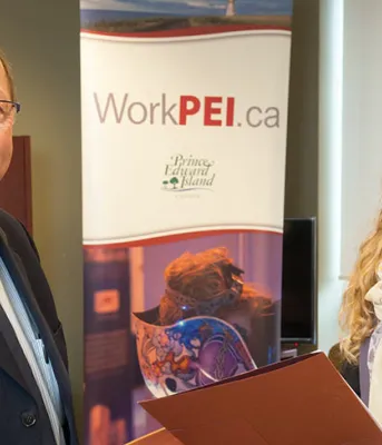 Two people looiking at the Career Fairs schedule