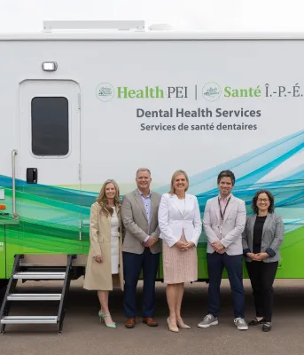 The Minister and others pictured in front of the mobile bus
