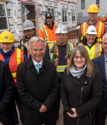 Canada supports affordable housing in Charlottetown image of people standing shoulder to shoulder at a construction worksite