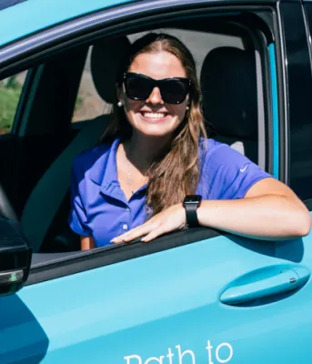 image of person sitting in a blue car