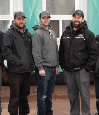 image of people standing shoulder to shoulder in front of a building