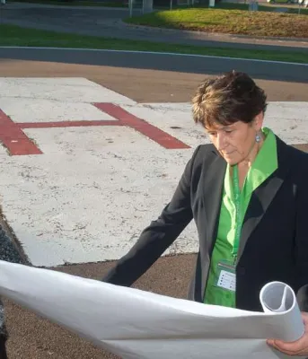 Helipad upgrades at Prince County Hospital Minister Biggar and Minister henderson and one other person review construction plans near the PCH Helipad