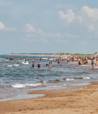 Funding support for tourism operators image of a beach with a people on it.