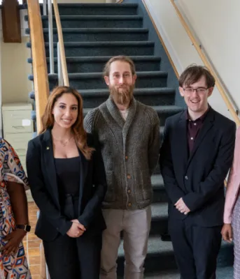 Provincial grants for student housing study image of people standing shoulder to shoulder in a building at the bottom of stairs