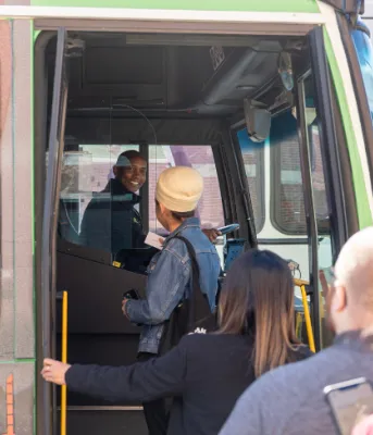 Province invests to freeze public transit fares again image of people getting onto a transit bus