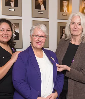 Representatives from four community organizations that will receive funding to help Island women feel safe from the threat of violence stand with Minister Paula Biggar