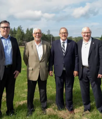 Improvements to PEI’s highway system will benefit residents and visitors with safer, more efficient roads and bridges Four men standing shoulder to shoulder in a field
