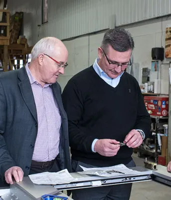 Positioning Silliker Glass for future growth in Borden-Carleton Photo shows four men examining a piece of glass