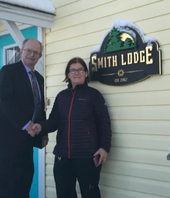 More transitional housing support for Islanders Two people standing in front of a house
