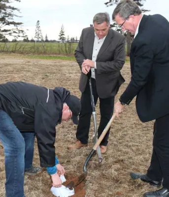 Ministers Mitchell McIsaac Environment Minister Robert Mitchell and Agriculture Minister Alan McIsaac bury a pair of white cotton brief to test the quality of Island soil