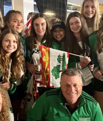 Statement by Premier Dennis King on Team PEI competing at the 2022 Canada Games image of a group of people shoulder to shoulder in team PEI green and holding PEI flags