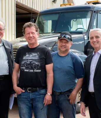 Team Youth Trucking expands student jobs Six people standing with a large truck in the background.