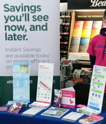 Person standing behind display table of brochures