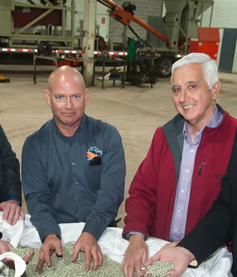 New Leaf Essentials East brings new jobs to Slemon Park Four people staqnding behind a large bag of peas.
