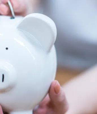 Response to the federal government’s decision regarding its Climate Change Plan person placing a coin in a white piggybank