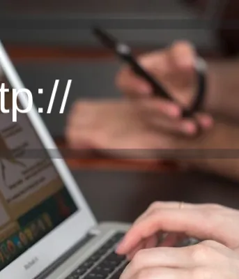 PEI Broadband Fund Image of individual using a laptop with text that reads "http://..."